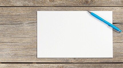 Blank White Paper with a Blue Pen on a Rustic Wooden Table