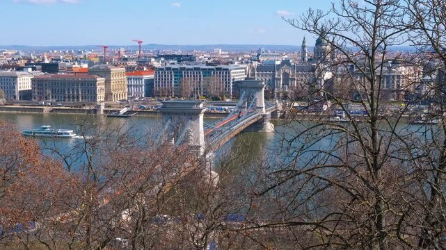Danube river with secheni bridge. A nice traveling cityscape on Danube river bank with chained bridge against clear blue sky.