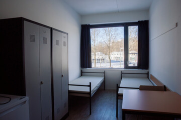 Small bedroom in a Dutch asylum seekers center showcases simple living conditions