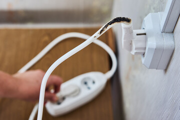 Power strip extension cord overload with burn marks on it.