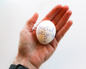 abstract open palm of hand holding egg metaphor retirement social security financial planning isolated on a white background
