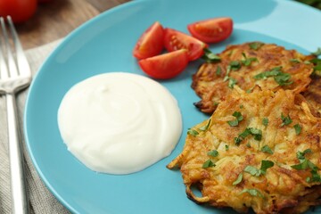 Delicious potato pancakes served on table, closeup