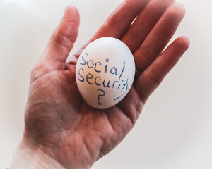 abstract open palm of hand holding egg metaphor retirement social security financial planning isolated on a white background