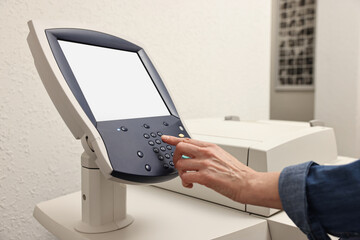 Woman using modern printer indoors, closeup. Printing house