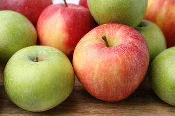 Fresh ripe apples on wooden table, closeup