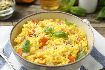 Delicious pumpkin risotto served on table, closeup