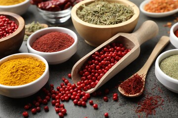 Different aromatic spices on grey table, closeup