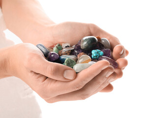 Woman holding different natural mineral stones on white background, closeup