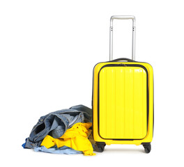 Suitcase and messy pile of clothes isolated on white