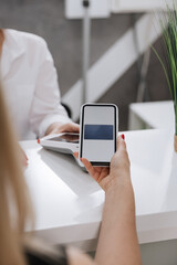 Secure mobile payment with smartphone at modern clinic reception desk for cashless transactions