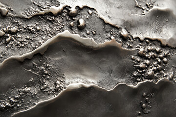 A tarnished silver surface with dark oxidation spots and uneven textures, adding an antique, mysterious charm.