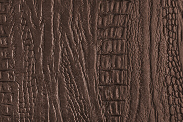 Crocodile genuine leather structure texture macro, brown colored leatherette surface with metallic, pearlescent effect. Reptile skin close up, macro background, wallpaper, backdrop