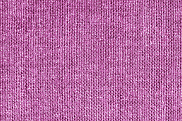 Upholstery pink colored jacquard fabric coarse weave texture close up, macro. Textile background, furniture textile material, wallpaper, backdrop. Cloth structure close up, macro