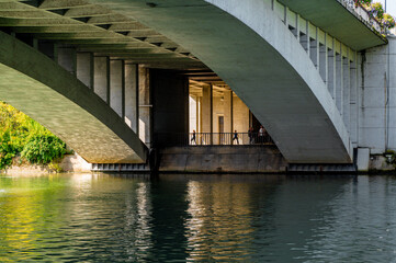 Paris, France. View under the Joinville Bridge over the Marne River in Paris. People doing fitness...