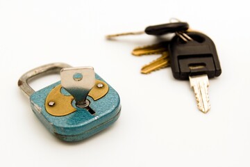 PADLOCK AND KEY ON A WHITE BACKGROUND