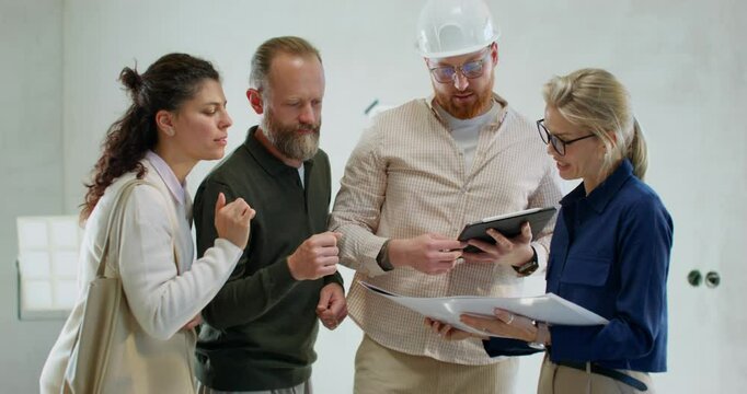 A married couple discusses construction details with a foreman and a designer