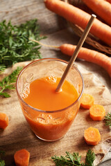A glass of fresh carrot juice with ecological paper straw. Zero waste.