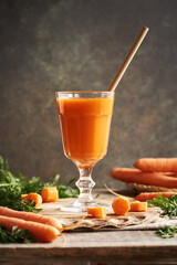 A cup of fresh carrot juice with recyclable bamboo straw. Zero waste.