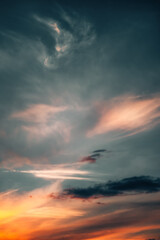 Dramatic sunset sky with soft, colorful clouds blending hues of orange, red, and blue. Scenic...