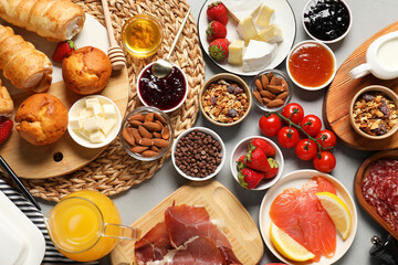 Different tasty food served for brunch on grey table, flat lay