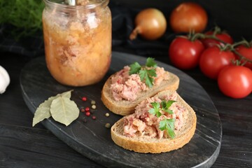 Sandwiches with canned meat served on wooden table, closeup
