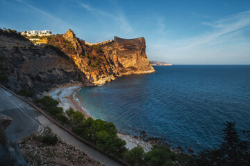 The rock rises above the blue sea