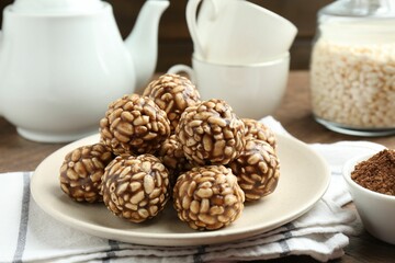 Tasty chocolate puffed rice balls served on table, closeup