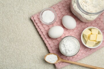 Baking powder and other ingredients for making dough on table, top view. Space for text