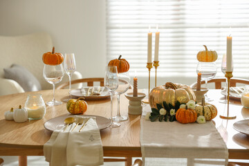 Stylish dining room with beautiful table setting and autumn decor