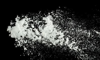 Snow dust element falling over dark night. Fluffy White snow splash flying or throwing in mid air. Snowfall on Black background isolated
