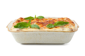 Delicious cooked lasagna in baking dish and basil isolated on white