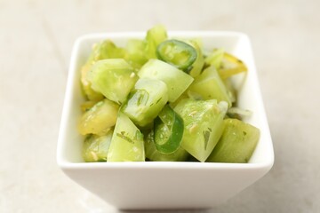 Delicious salsa (Pico de gallo) in bowl on light table, closeup