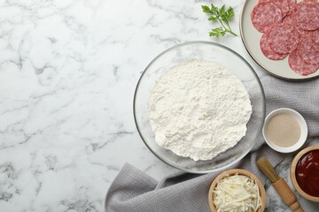 Making calzone pizza. Different ingredients on white marble table, flat lay. Space for text