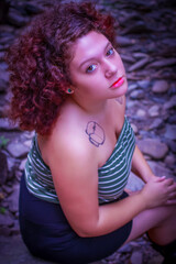 Beautiful woman with curly hair near the water