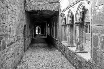Fototapeta premium A long, narrow hallway with a person walking down it