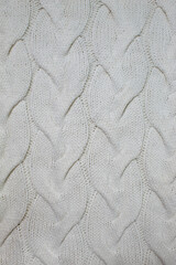 Knitted wool sweater clothing on a light surface slow fashion. Background texture