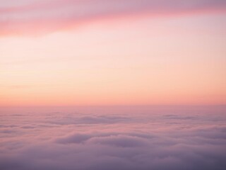 Soft pink clouds fill the sky during a peaceful sunset over a tranquil landscape, light, pink