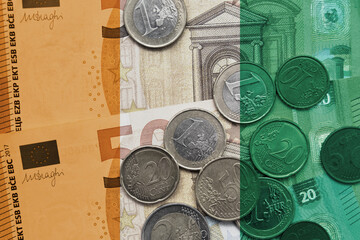 colourful national flag of ivory coast on a euro money banknotes and coins background. finance...