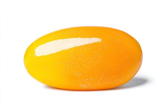 Close-up of yellow mango jelly bean candy with sugar crystals on white background