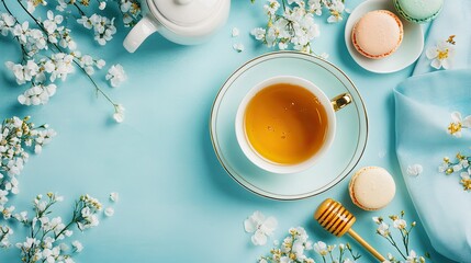 Delicate Tea Setup with Cookies and Floral Accents on Blue Surface