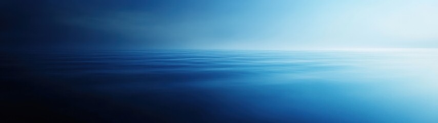 Obraz premium A serene view of calm ocean waters under a soft blue gradient sky.