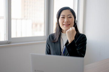 ガッツポーズをしたヘッドセットの女性