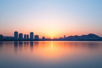 Fototapeta premium Tranquil cityscape sunset over calm water with silhouetted buildings