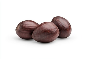 Fototapeta premium Three whole brown nutmeg seeds on a white background