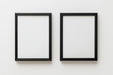Two black framed white picture frames on a white wall