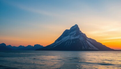 mountain in the distance with a body of water in the foreground