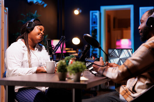Black male and female content creators doing podcasts, making live discussions for online listeners. African american man and woman using recording equipment to broadcast their talk show. - Powered by Adobe