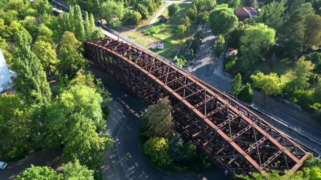 Yellow train crossing bridge Former border Berlin. Amazing aerial view drone
