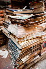Stack of Aged Books With Worn Covers and Weathered Pages in Atmospheric Setting
