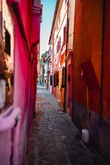 Colorful Alleyway in Burano, Venice Showing Vibrant Buildings In Daylight